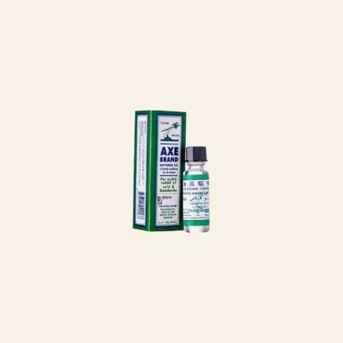 Axe Brand Universal Oil 3 ml bottle and retail box on a warm cream background