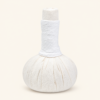 One Poompuksa 200 g Thai herbal compress ball on a plain warm ivory background