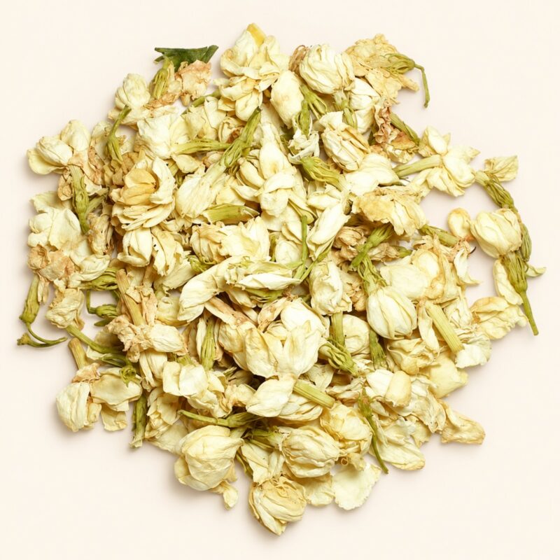 Whole dried jasmine flower buds on a warm cream background