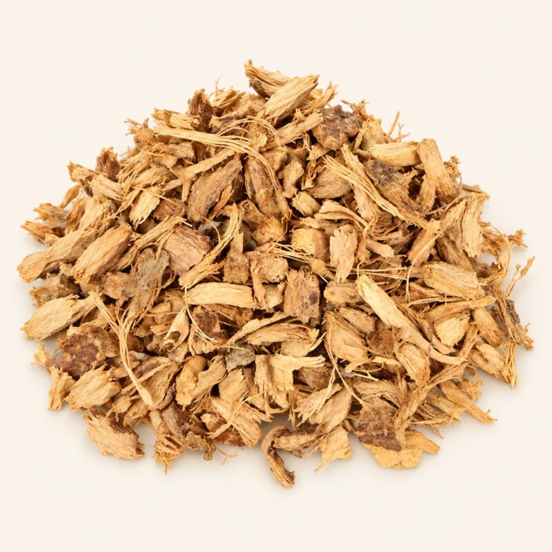 Cut dried galangal root pieces on a warm cream background