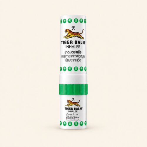 Tiger Balm two-in-one inhaler 2 ml on a warm cream background